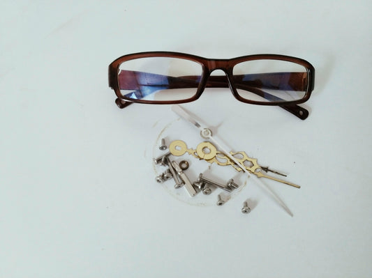 black framed eyeglasses on white table