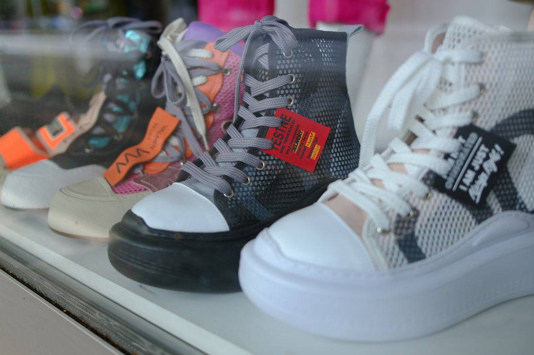 A row of colorful high-top sneakers displayed in a store.